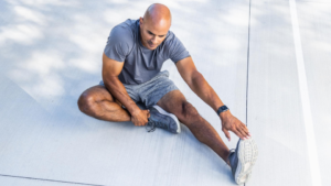 2025 Health Trends, man stretching with wearable watch